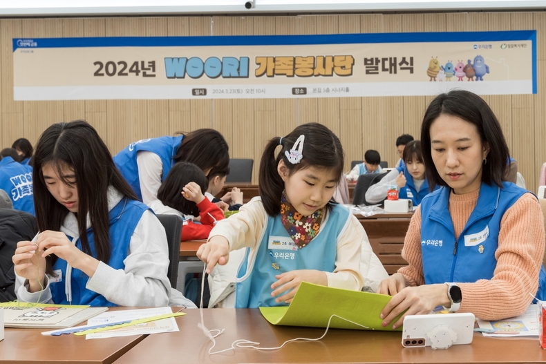 우리은행 직원과 가족들이 봉사단 발대식에 참여해 시각장애아동을 위한 점자촉각교구재를 만들고 있다. ⓒ타임즈 