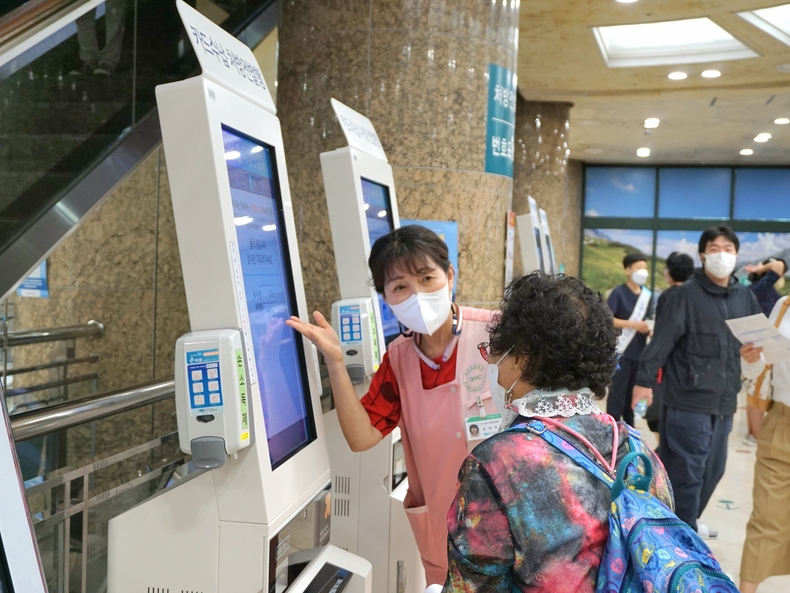 분당제생병원 처방전 발행기 앞에서 활동하는 자원봉사자 ⓒ타임즈 