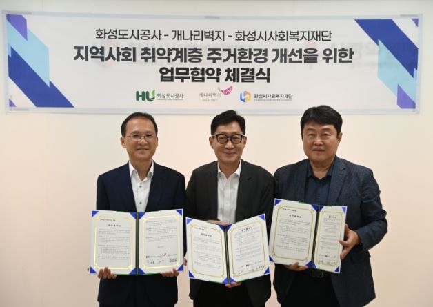 성시사회복지재단에서 김근영 화성도시공사 사장(왼쪽), 김훈 개나리벽지 대표이사(가운데), 고원준 화성시사회복지재단 대표이사(오른쪽)가 사회공헌 업무협약서를 들고 있다.(화성도시공사 제공)