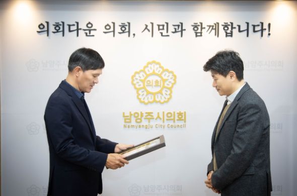 남양주시의회 김현택 의장(좌)이 성경훈 센터장(우)에게 표창을 수여하고 있다. ⓒ타임즈