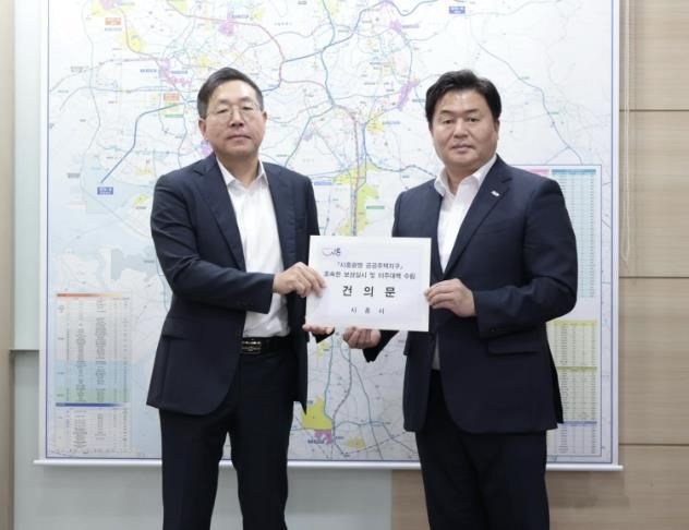 임병택 시흥시장은 최용택 LH 광명시흥사업본부장(사진 왼쪽)에게 건의문을 전달했다